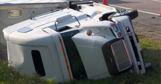 Semi truck on its side