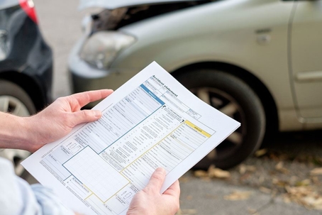 holding a paper at a crash scene