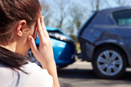Woman looking at a car accident